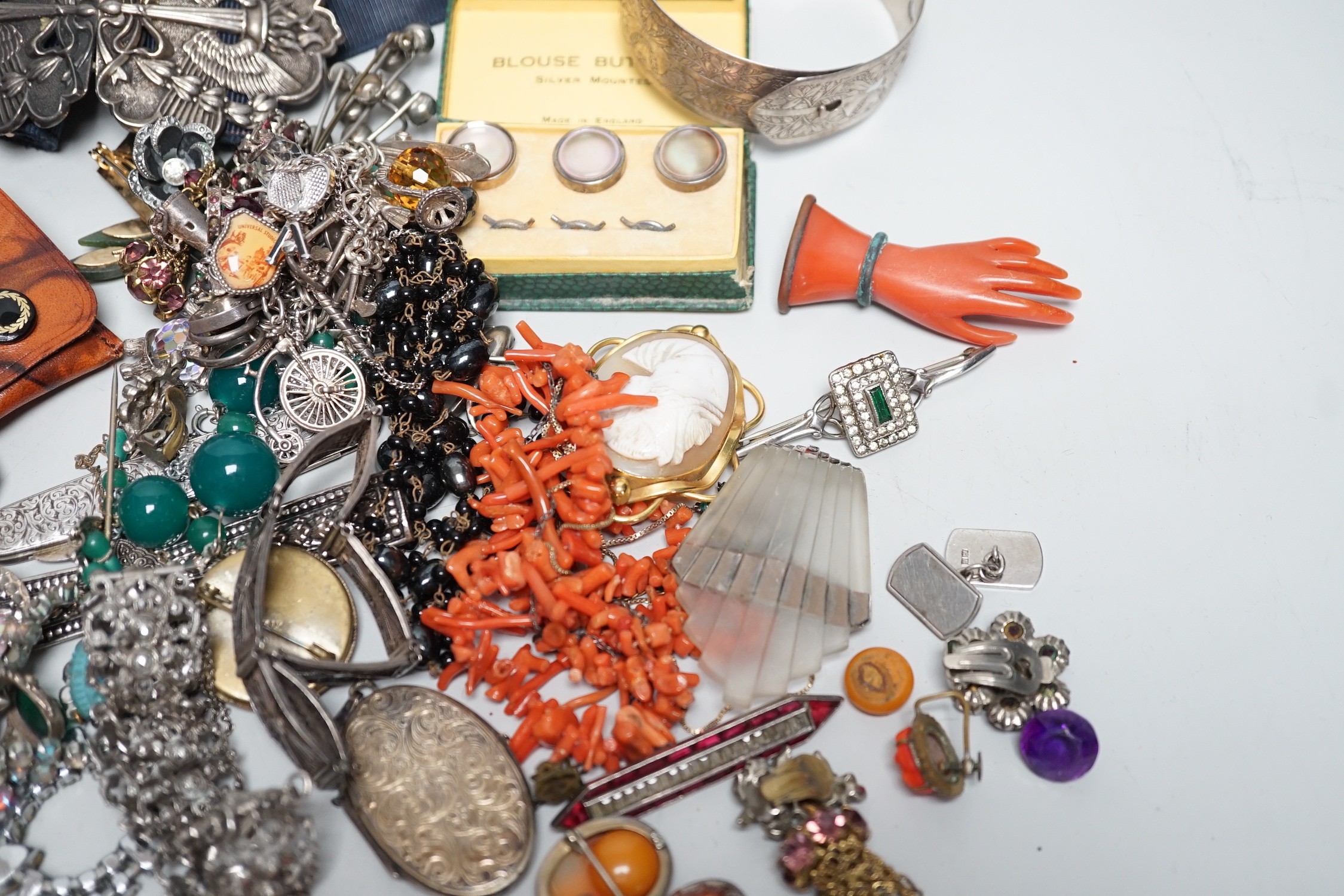 Assorted costume jewellery and other items including a silver belt buckle and enamelled egg pendant.